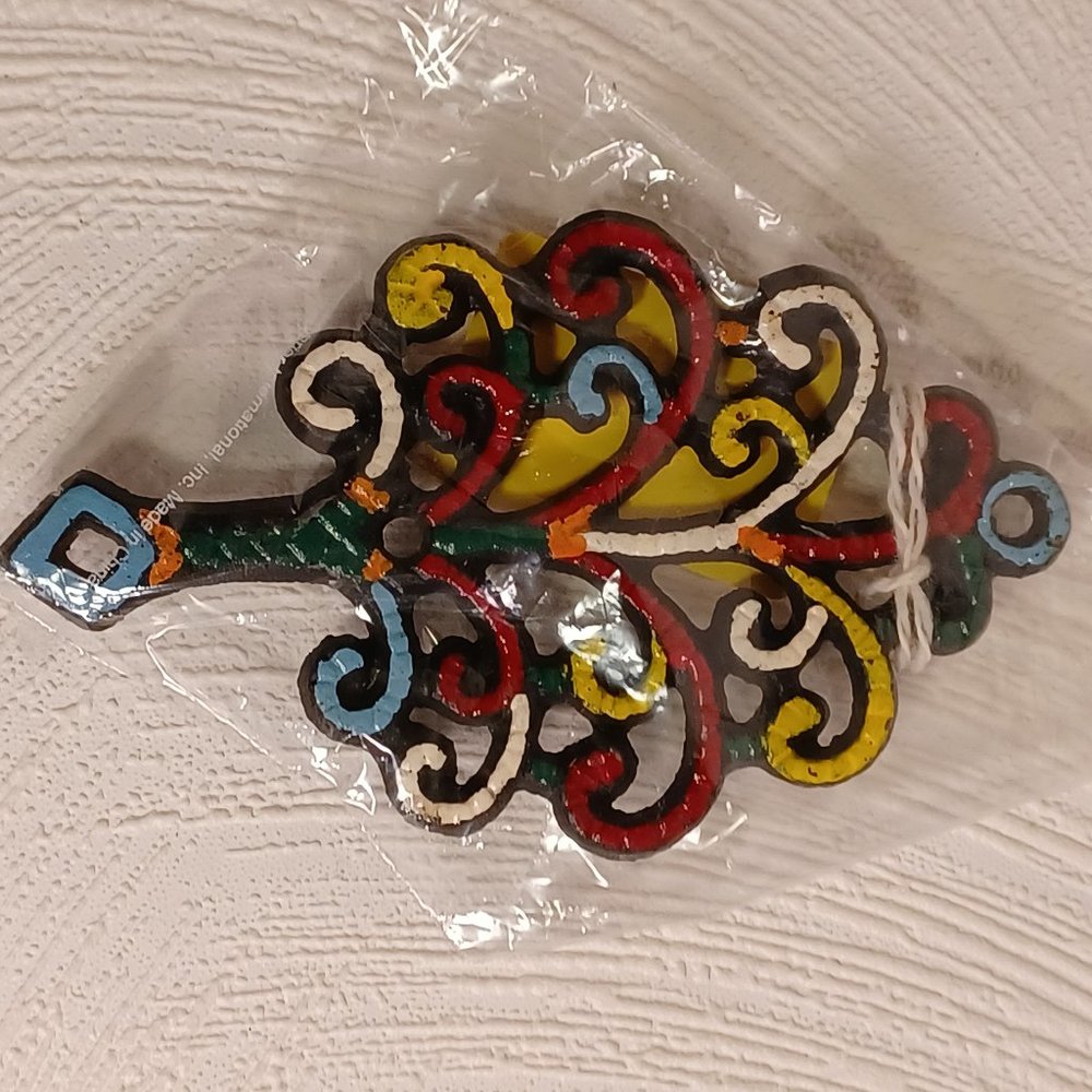 trivet tree of life black cast iron painted many colors